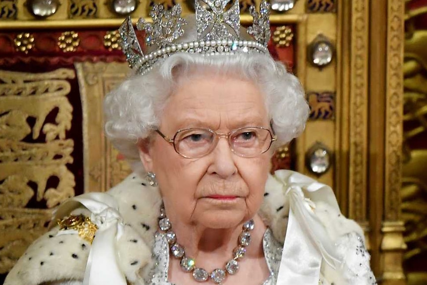 Queen Elizabeth and Prince Charles sitting in the House of Lords.