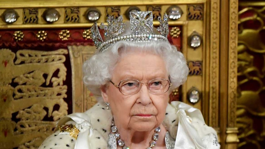 Queen Elizabeth and Prince Charles sitting in the House of Lords.