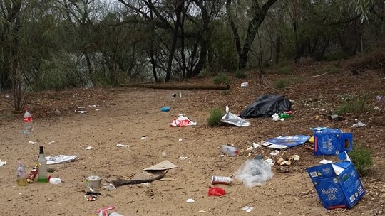Boxes, bottles, plastic and other rubbish strewn along the riverfront near the Cadell ferry.