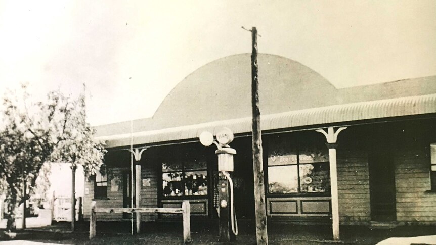 A black and white image of the Eulo General Store in the early 1900s with a petrol pump outside.