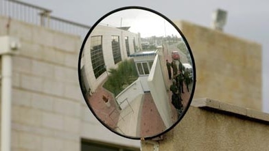 Palestinian policemen stand guard outside the American International school in northern Gaza.