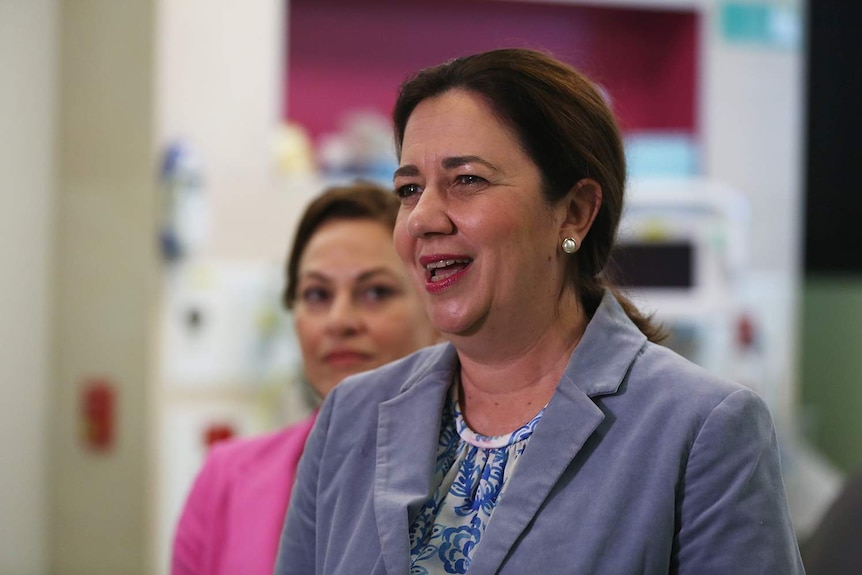 Queensland Premier Annastacia Palaszczuk speaks to media, with Deputy Premier Jackie Trad in background.