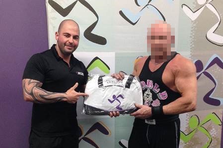 Gym manager and OMCG bikie, Daniel Sarkis, pictured with a staffer.