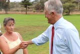 Raylene Mullins shakes hands with Malcolm Turnbull in a public park.