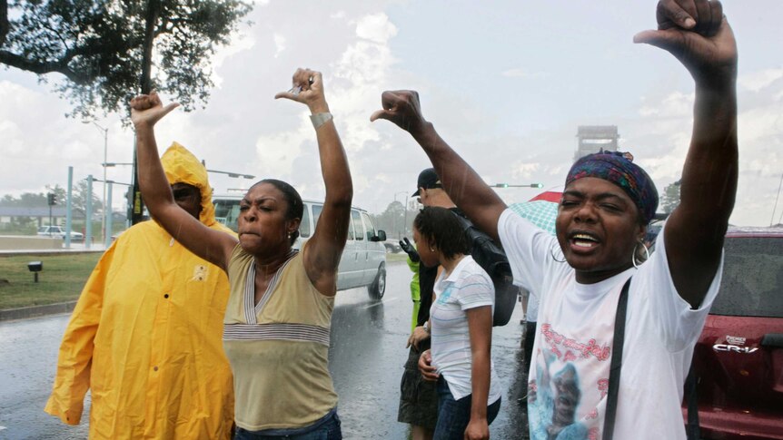 Protesters give the thumbs down to US President George W Bush' motorcade in New Orleans, Louisiana.