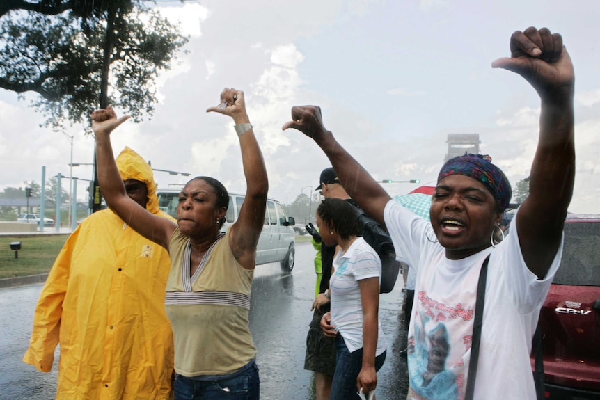 Protesters give the thumbs down to US President George W Bush' motorcade in New Orleans, Louisiana.