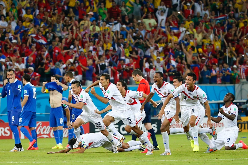 Costa Rica's players celebrate after winning the penalty shootout against Greece at the World Cup.