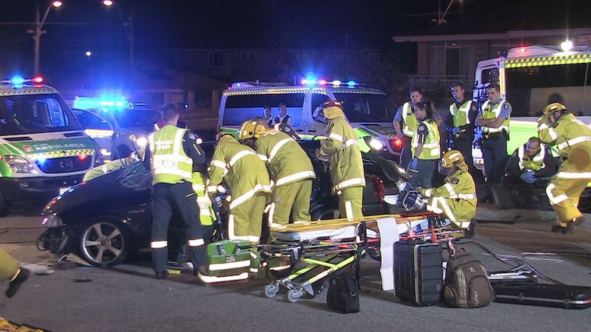 Emergency service workers at the scene of a car crash which left a man with critical injuries.