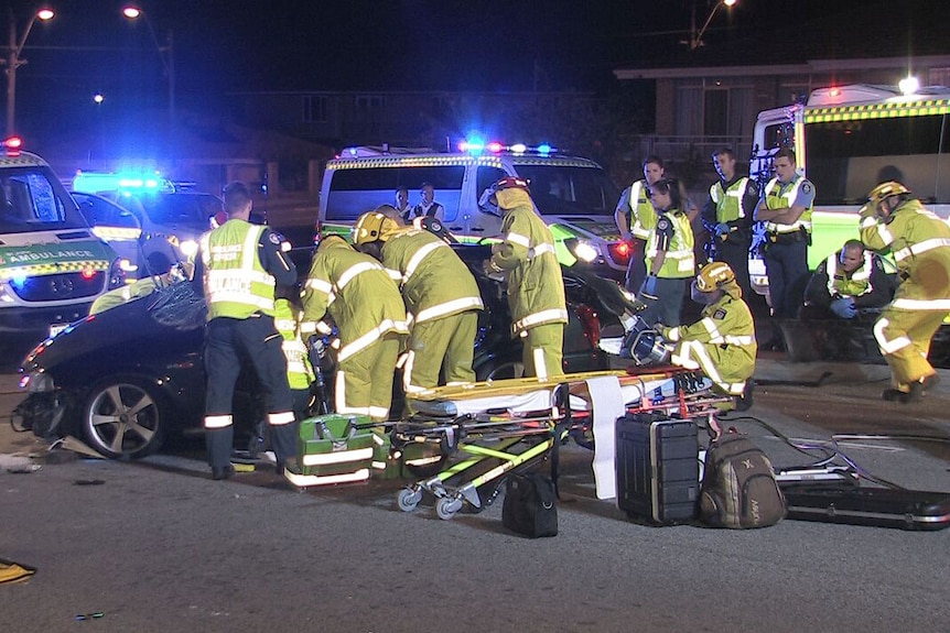 Emergency service workers at the scene of a car crash which left a man with critical injuries.
