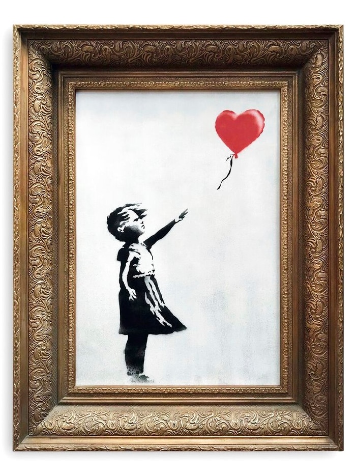 A black and white painting in a thick gold frame of a girl reaching into the air as a love-heart shaped balloon floats away