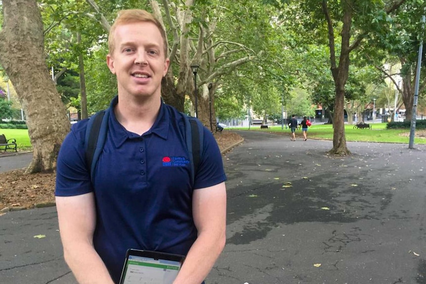 Daniel Cray standing in Belmore park with an iPad.