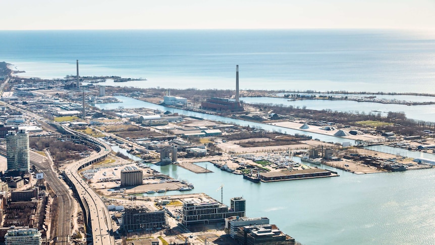 An aerial photo of a large industrial area by the waterfront.