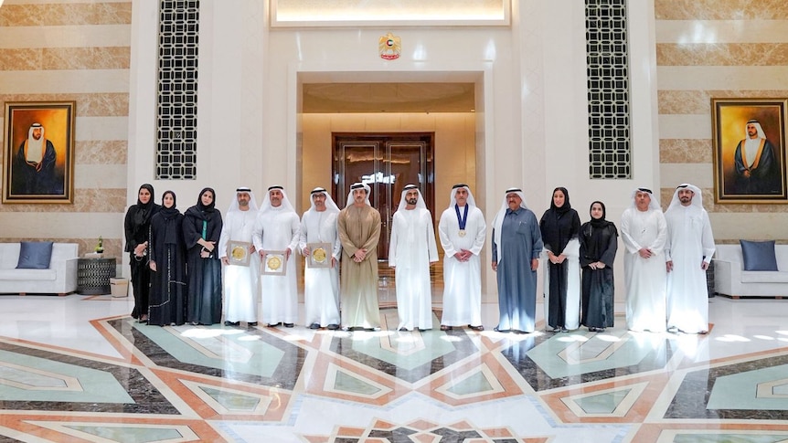 Five women stand next to the male winners of the gender equality awards.