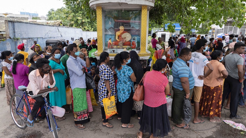 People standing in a queue in Sri Lanka.