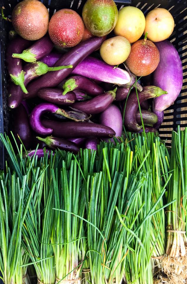 A photo of fresh pick fruit and vegetables in a box.