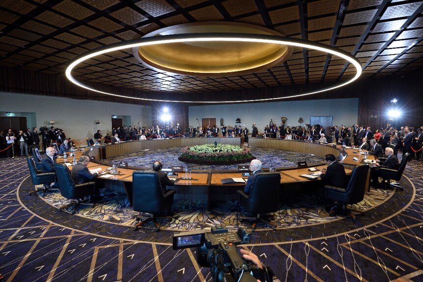 The shot of the round desk is the leaders meeting underway at 2018 APEC Economic Leaders' Meeting  Haus.
