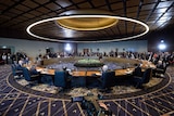 The shot of the round desk is the leaders meeting underway at 2018 APEC Economic Leaders' Meeting Haus.