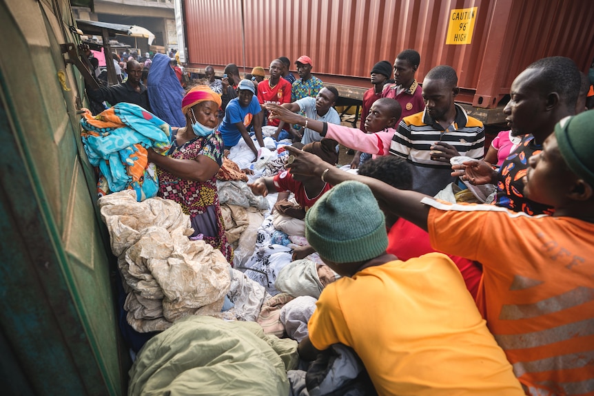 Men reach for clothing.