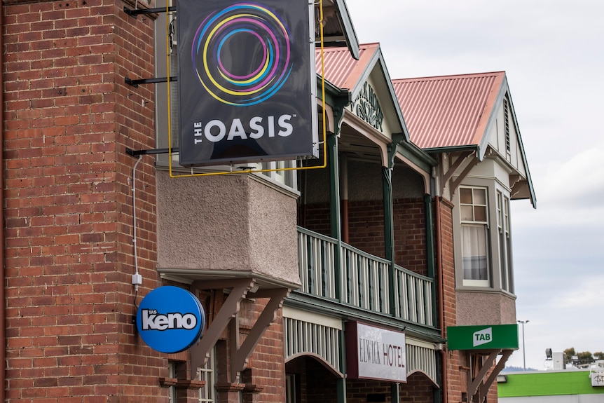 Gambling signs on the exterior of a brick pub in Glenorchy.