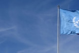 United Nations flag flying outside Geneva UN headquarters.