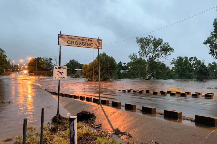 A road crossing with water rushing over it.