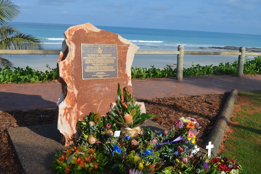 Flowers are laid before a memorial for two RAAF crew killed when their plane crashed off Broome in 1944