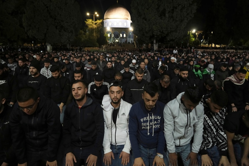 Thousands of men pray in the courtyard of the Al-Aqsa Mosque before dawn.