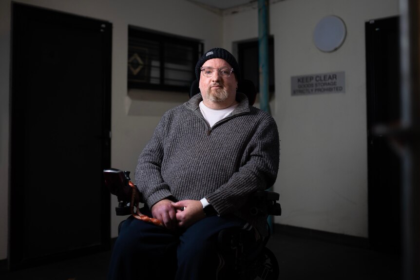 Moody portrait of a man in a faulty social housing complex.