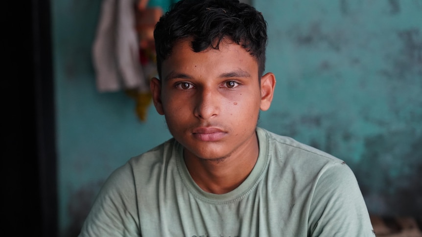 A teenaged Indian boy looking solemn 
