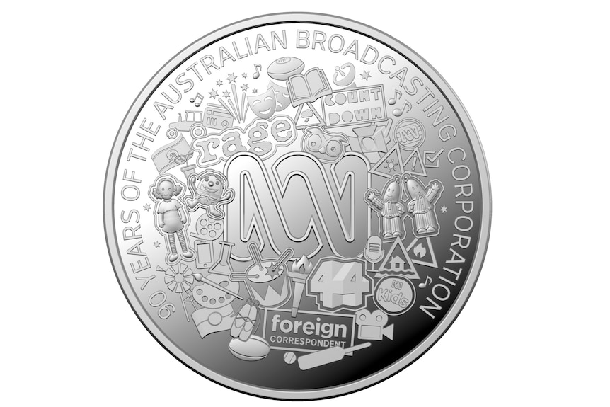 A round silver coin with the ABC logo.