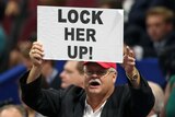 Male delegate holds up 'lock her up' sign