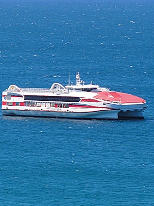 A large red-and-white ferry on the ocean
