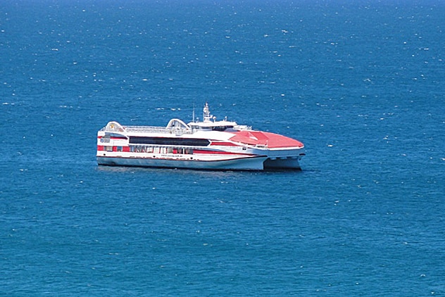 A red and white vehicular ferry at sea