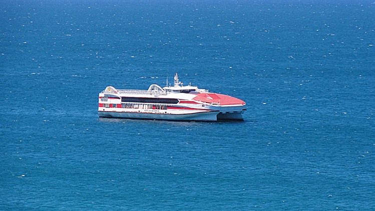 A large red-and-white ferry on the ocean