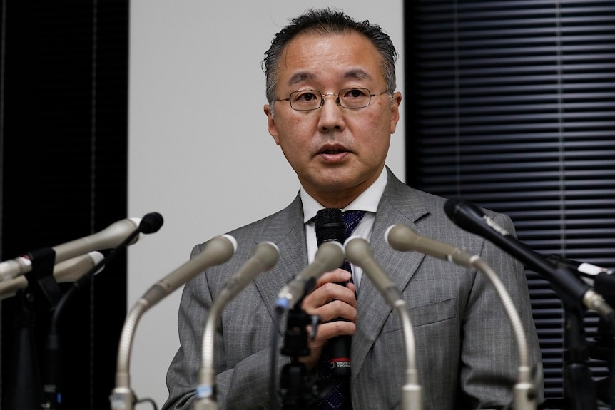 Noriyuki Yamaguchi speaking during a news conference.