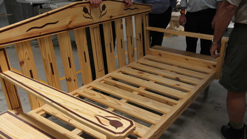 Prisoners and prison guards have made a wooden outdoor seat