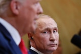 Russian President Vladimir Putin listens to U.S. President Donald Trump
