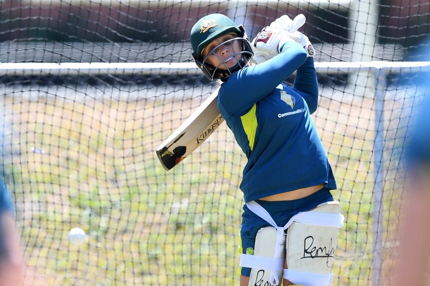Ashleigh Gardner swings the bat behind her while in the nets.