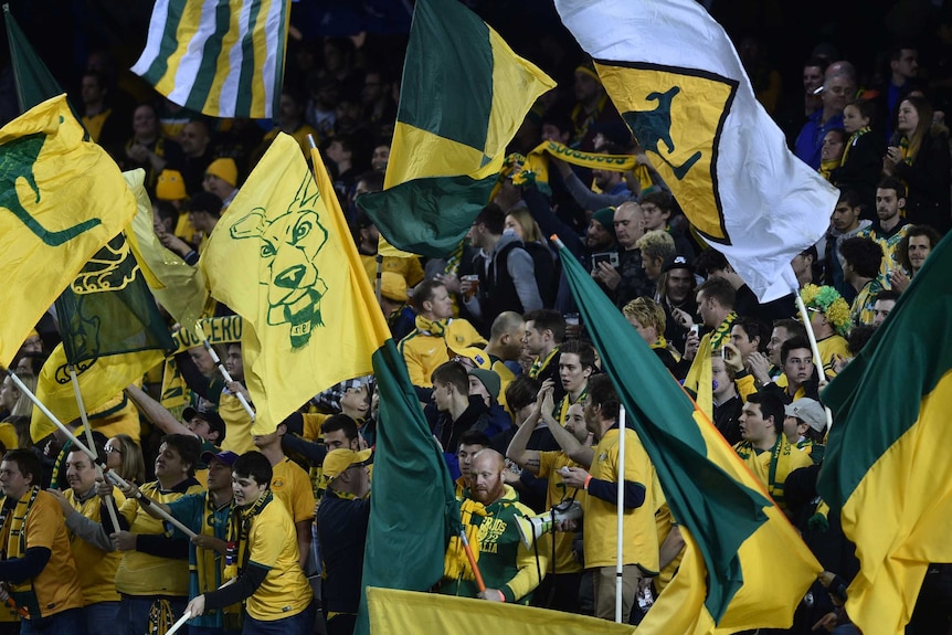 Socceroos fans wave banners ahead of World Cup qualifier against Japan.