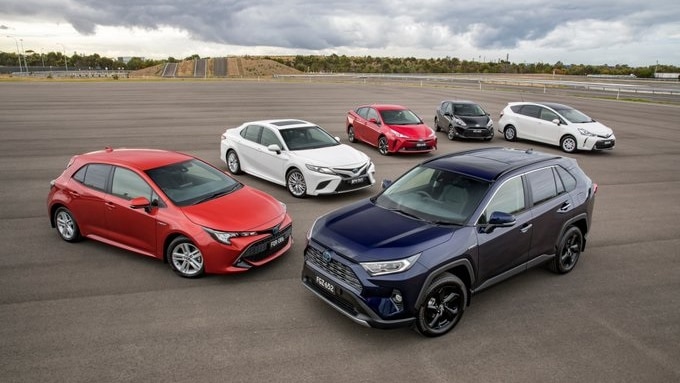 Six cars are arranged and photographed while parked on an open asphalt area.