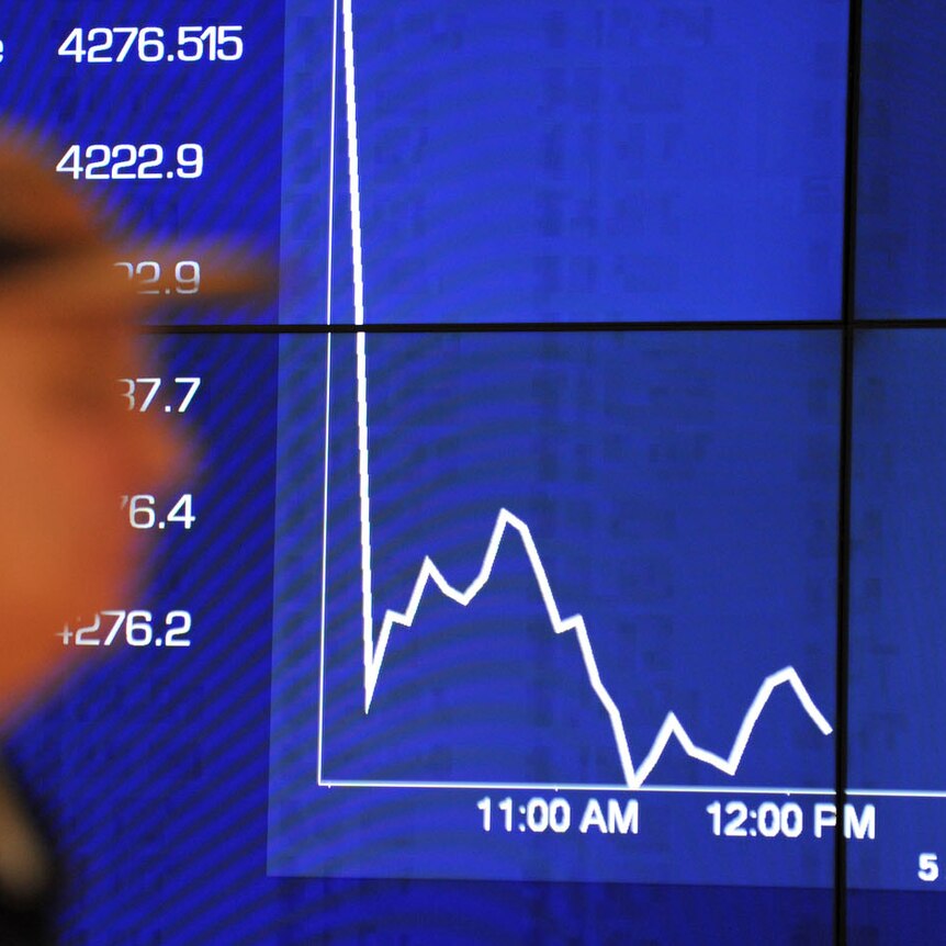 Passers-by watch the share market plunge on an Australian Stock Exchange graph in Sydney on August 5, 2011.