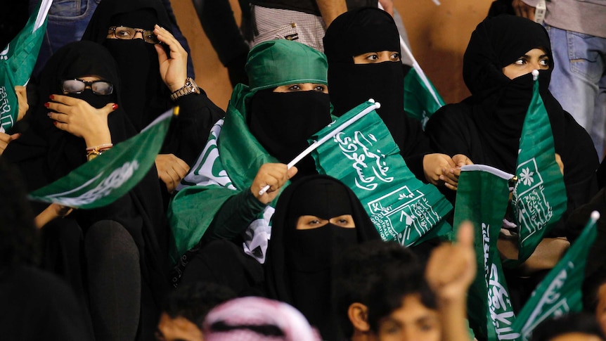 Female fans of Saudi Arabia's soccer team show their support.