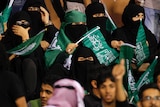 Female fans of Saudi Arabia's soccer team show their support.