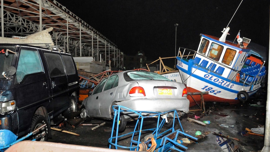 Vehicles and boats lie on the shore after a tsunami hit the northern Chilean port of Iquique.