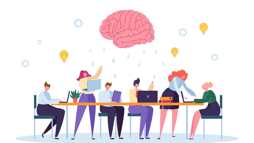 animation of people sitting around a worktable on laptops with a giant brain hovering overhead