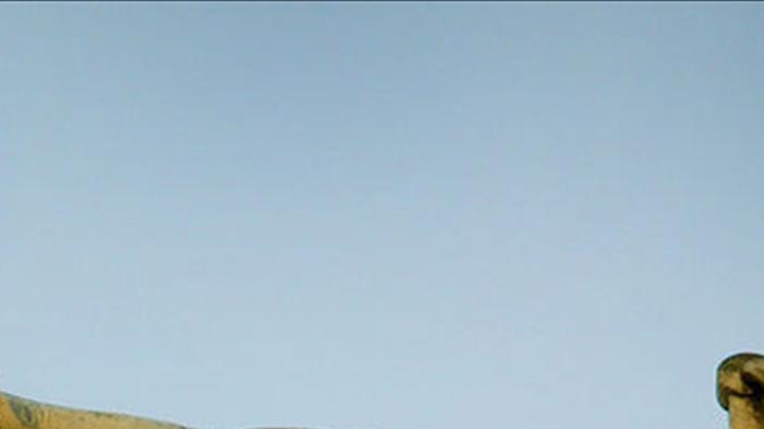 A statue holding the scales of justice is seen on top of the Old Bailey in London.