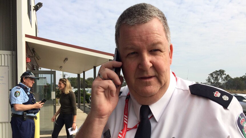 RFS Superintendent Michael Brett on his phone.