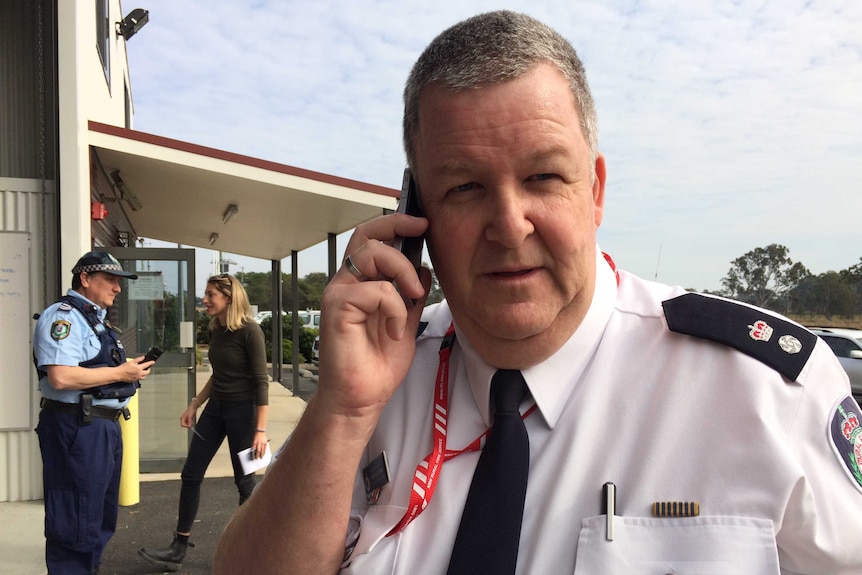 RFS Superintendent Michael Brett on his phone.