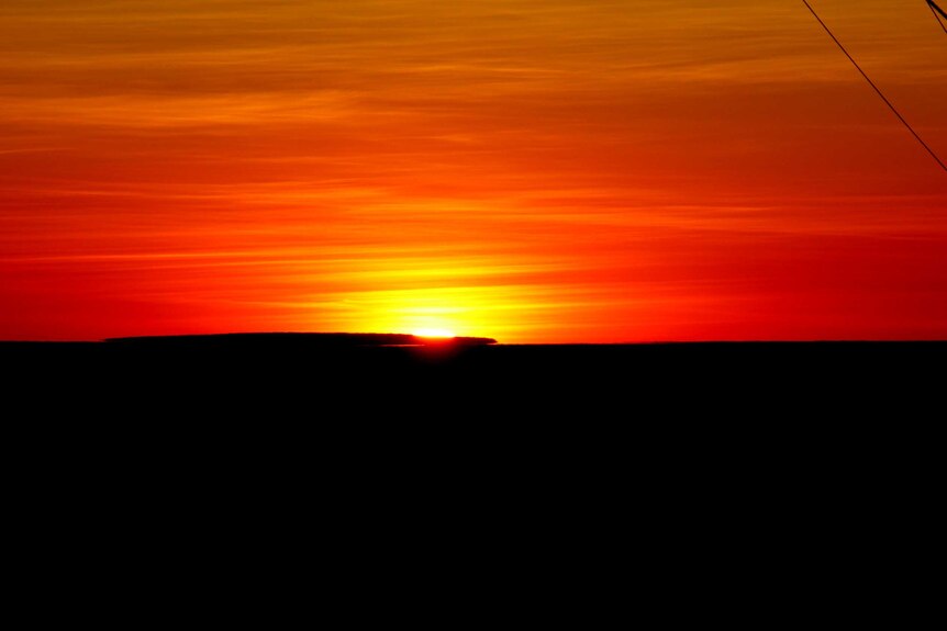 The sun rises over the landscape near Roebourne in the WA Kimberley.
