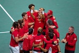 Canada's Davis Cup tennis team celebrate on court in big group huge.